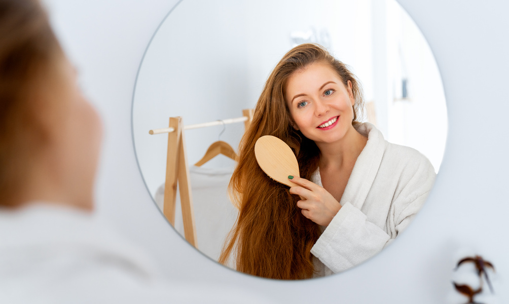 woman brushing her red hair